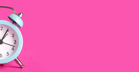Alarm clock on pink background