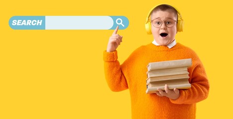 Surprised little boy with headphones and books using web search engine against yellow background