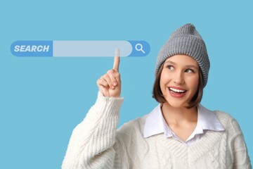 Young girl using web search engine against blue background