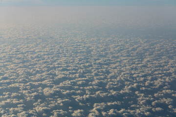 Stratosphere, view of water through clouds. Seascape, view from above, from an airplane window.