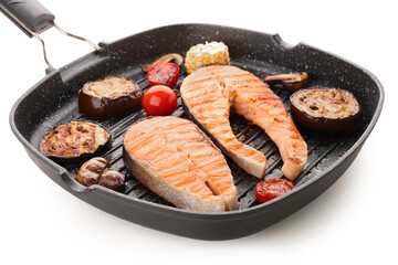 Frying pan with tasty grilled salmon steak and vegetables on white background