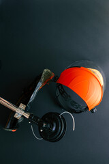 Brush cutter head with cutting line and protective safety helmet with face shield placed on black...