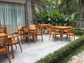 Outdoor Patio Seating Area with Wooden Chairs and Tables