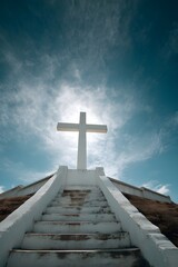 Ascending Stairs to a Large Cross Under Blue Sky