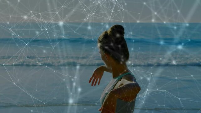 Woman starting side stretching at shore extending arms into Tshape with mesh tracking fitness data