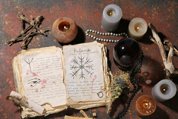 Witch's magic attributes with spell book on grunge background