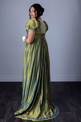 A Regency woman wearing an evening dress with gloves