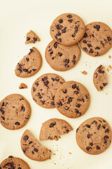 Tasty cookies with chocolate chips on yellow background