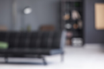 Blurred view of living room with black couch