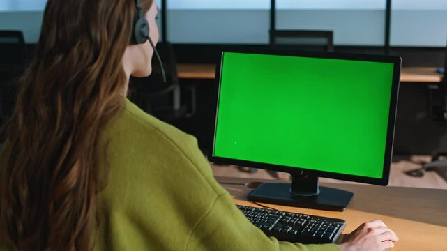 Call operator using mockup computer closeup. Woman manager looking green screen