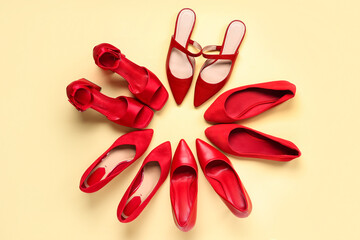 Frame made of red woman's shoes on beige background. Top view