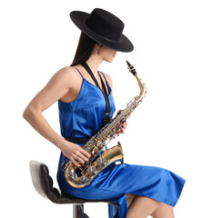 Beautiful young woman with saxophone sitting on white background