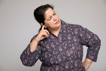 Indian mature woman have noise whistling in her ears. 
Ear pain Concept