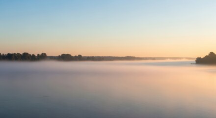 Naklejka premium Serene River Landscape During Sunrise with Mist and Calm Water