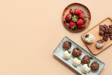 Plate and wooden board with chocolate covered strawberries on brown background