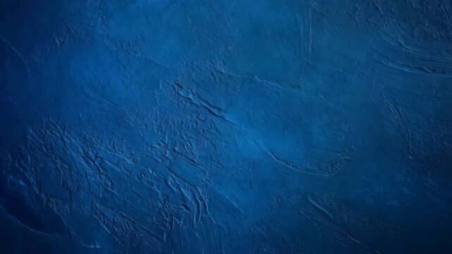 Textured blue stucco surface with artistic swirls, rough cast, abstract dark paint wall, for backgrounds and designs.