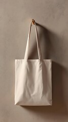 Ivory Canvas Tote Bag Hanging on Wooden Hook, Neutral Textured Wall Backdrop