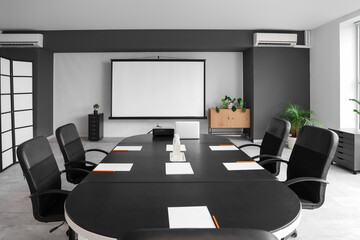 Interior of conference hall with table and projector screen