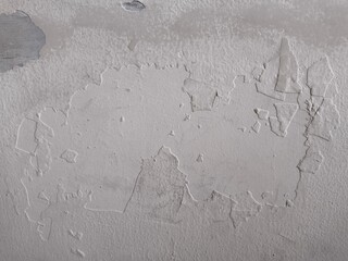 Close-up of weathered wall surface with chipped white paint. Suitable for creative compositions and digital use.