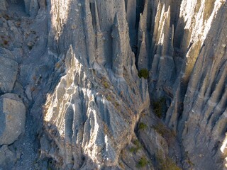 Aerial view of the Putangirua Pinnacles, a geological formation of rock pillars, located in the Aorangi Forest Park, New Zealand. Erosion created this landscape.
