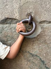 A person is holding a metal ring in their hand
