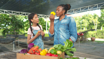 Smiling mom and daughter with a tray of fruit and vegetable