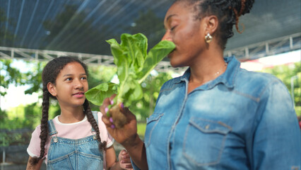 Smiling mom and daughter with a tray of fruit and vegetable