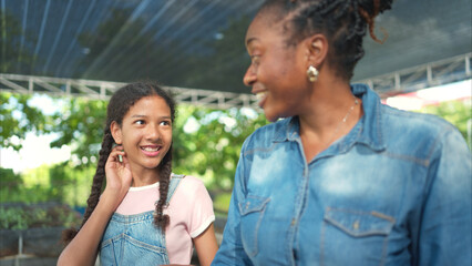 Smiling mom and daughter with a tray of fruit and vegetable