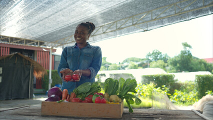 Portrait of woman with a tray of fruit and vegetable, enjoying a day of learning
