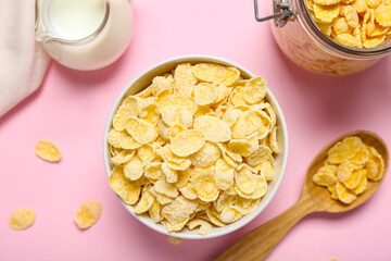 Bowl with delicious cornflakes on pink background, closeup