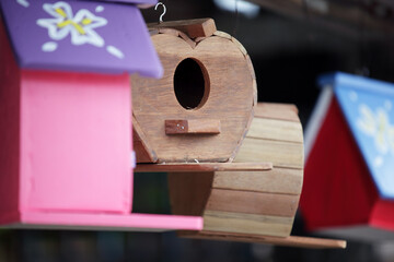 Colorful Wooden Birdhouses Hanging in a Garden Setting