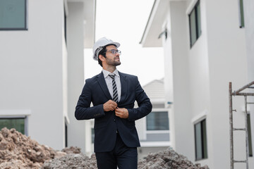 Business engineer control the worker employee to build construction. Young  architecture caucasian happy working at modern building construction site.
