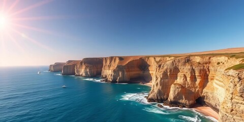 Fototapeta premium Sun-drenched cliffs meet azure sea; dramatic coastal scene, aerial view, nature