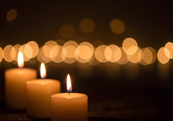 Serene Night: Three Candles Glowing in the Dark with Blurry Lights
