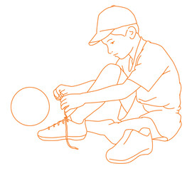 A little footballer boy tying his shoelaces at home