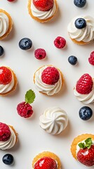 Delicious mini cupcakes adorned with fresh strawberries and blueberries on a light backdrop.