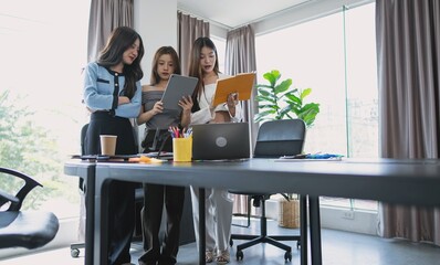 group of business people collaborating new project in office asian business woman team meeting discuss ideas Three female entrepreneurs.