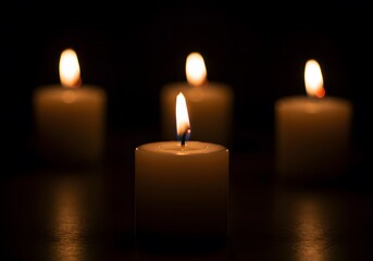 Serene Night: Four Candles Glow in the Darkness