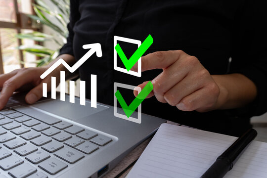 A business professional, with one hand on the keyboard and the other holding an arrow pointing to a green check mark and a digital line graph ascending in a white box