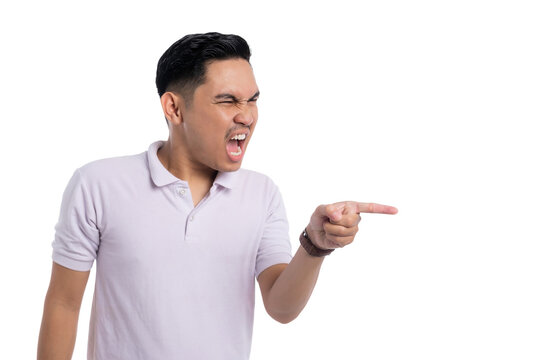 Angry young Asian man yelling and pointing finger aggressively to the side isolated on transparent background
