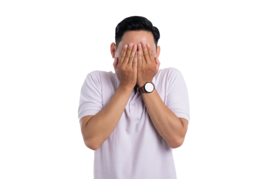 Embarrassed young Asian man covering his face with both hands isolated on transparent background