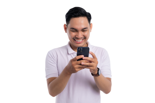 Happy young Asian man smiling while looking at smartphone screen isolated on transparent background
