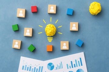 Creative Brainstorming Session with Colorful Blocks, Crumpled Paper Ball, and Charts on Blue Background