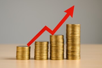 Financial Growth Concept with Stacked Coins and Red Arrow Depicting Increasing Trend in Revenue or Savings in Business or Investment Strategy