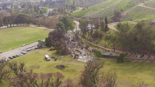 Aerial wide descending shot of the burned historic ranch house at Will Rogers State Park in Pacific Palisades, California. 4K