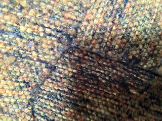 Close-Up Photograph of Vibrant Textured Fabric with Detailed Weave Pattern
