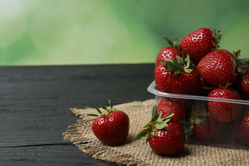 Strawberries on a wooden table in a container