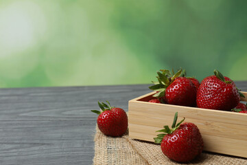 Strawberries on a wooden table in a container