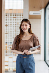 Happiness Entrepreneur beautiful business asian young woman standing holding laptop at office,...