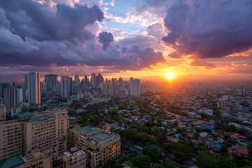 Obraz premium Aerial view of a cityscape at sunset with clouds and buildings in the distance